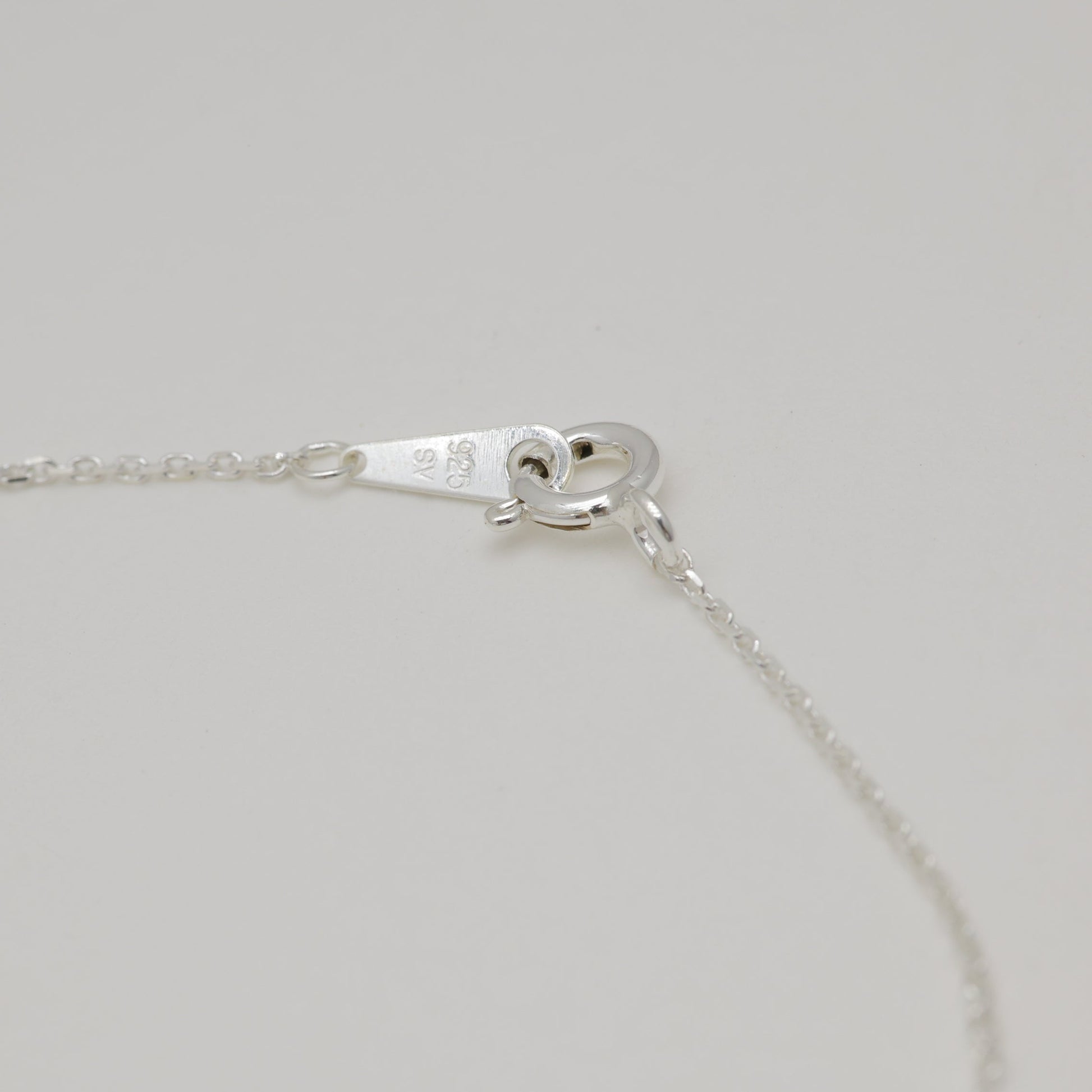 Sterling silver necklace clasp and hallmark detail.