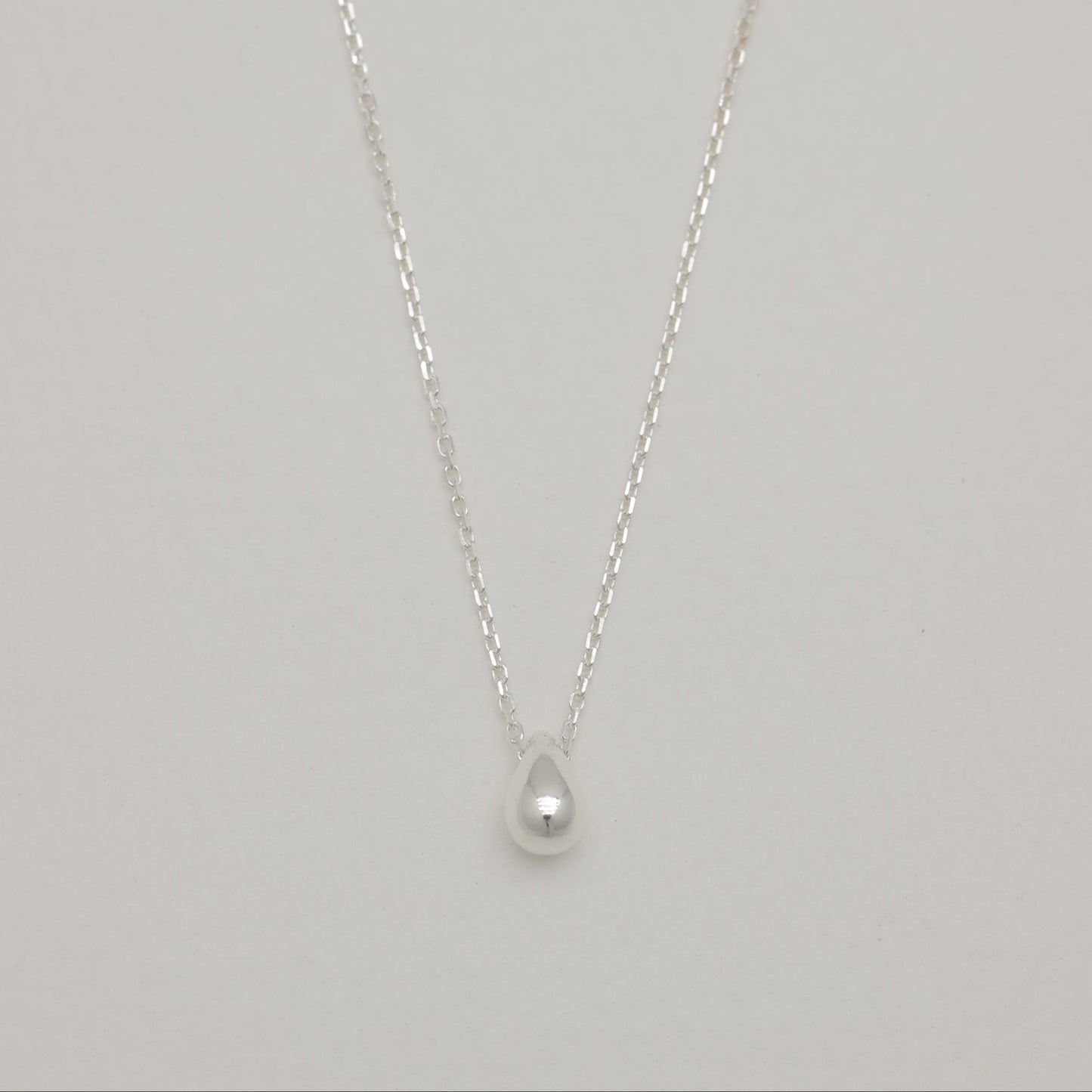 Front view of sterling silver droplet pendant necklace.