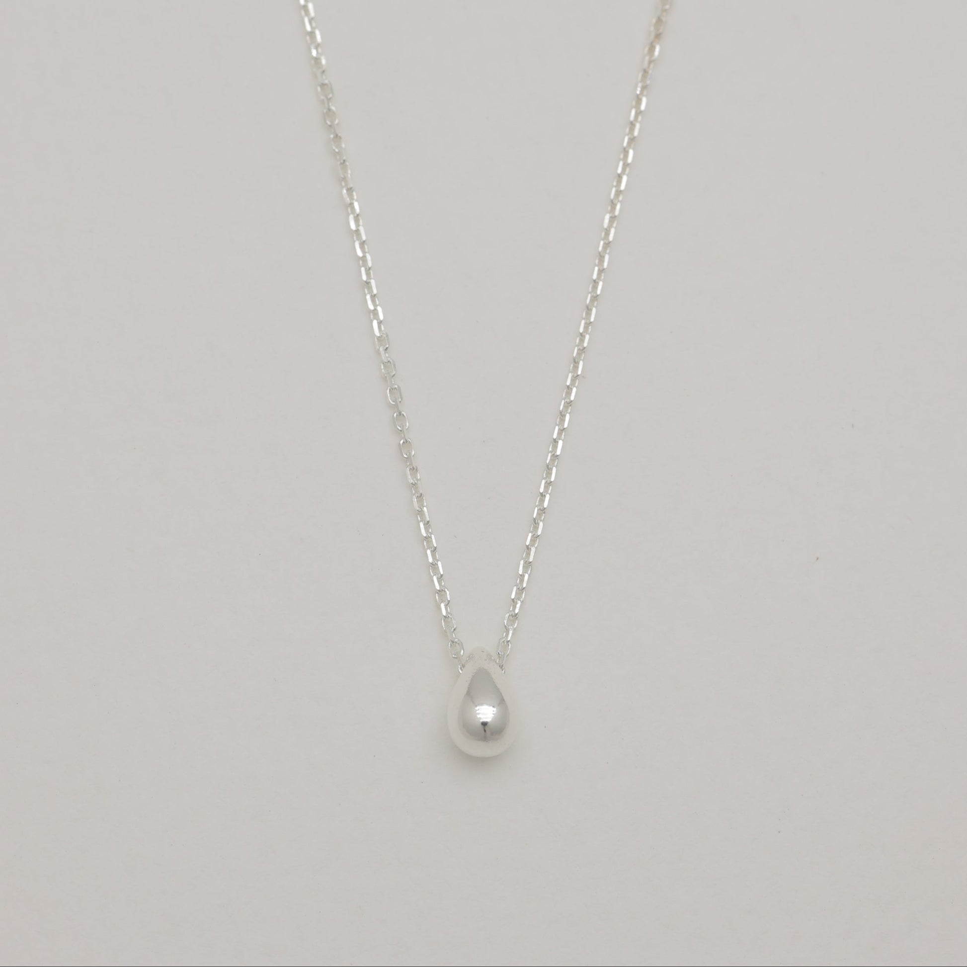 Front view of sterling silver droplet pendant necklace.