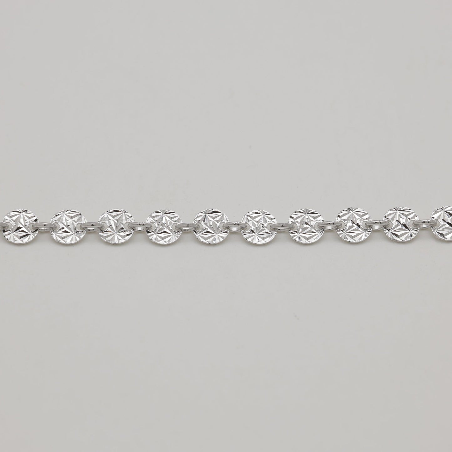 Silver bracelet on a light gray background