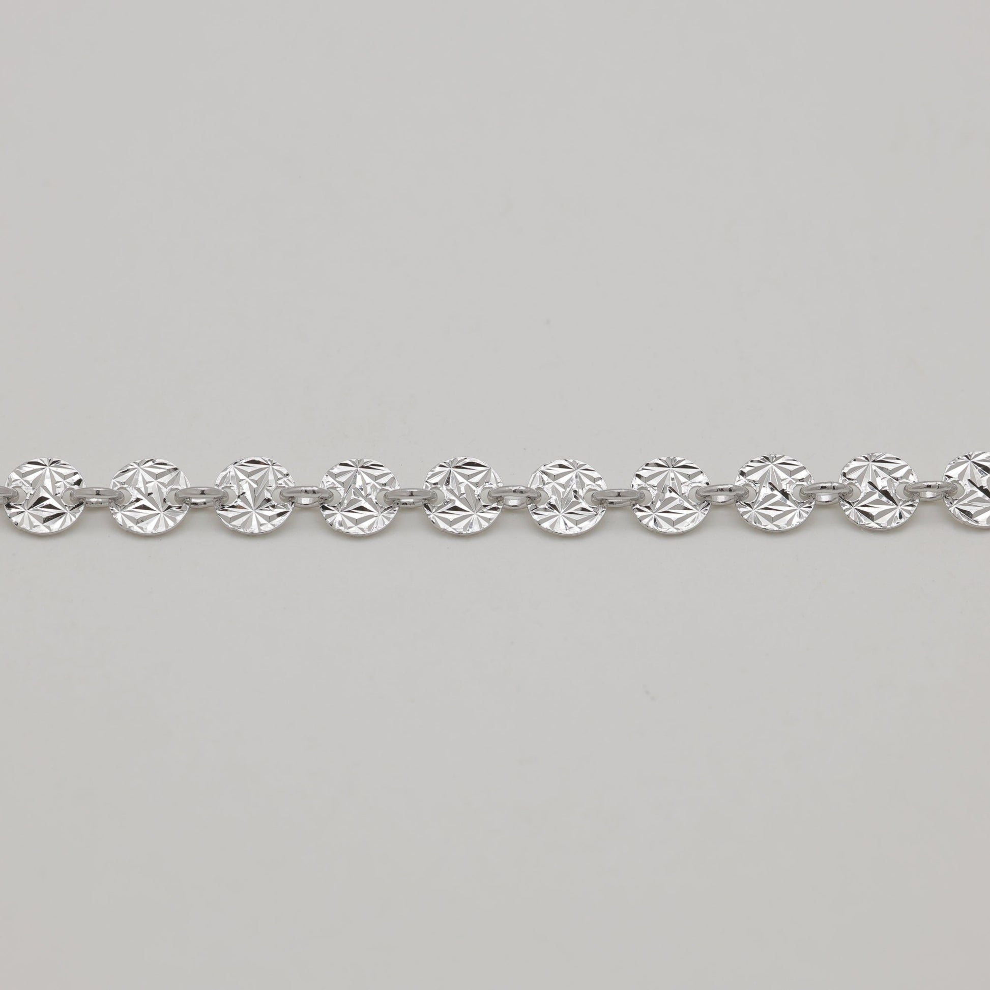 Silver bracelet on a light gray background