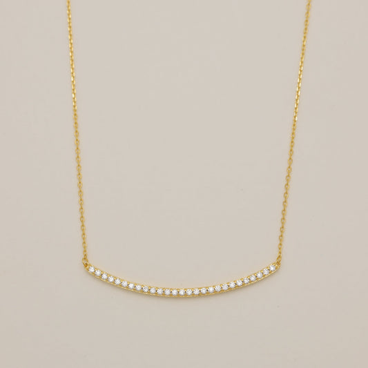 Gold necklace on a beige background