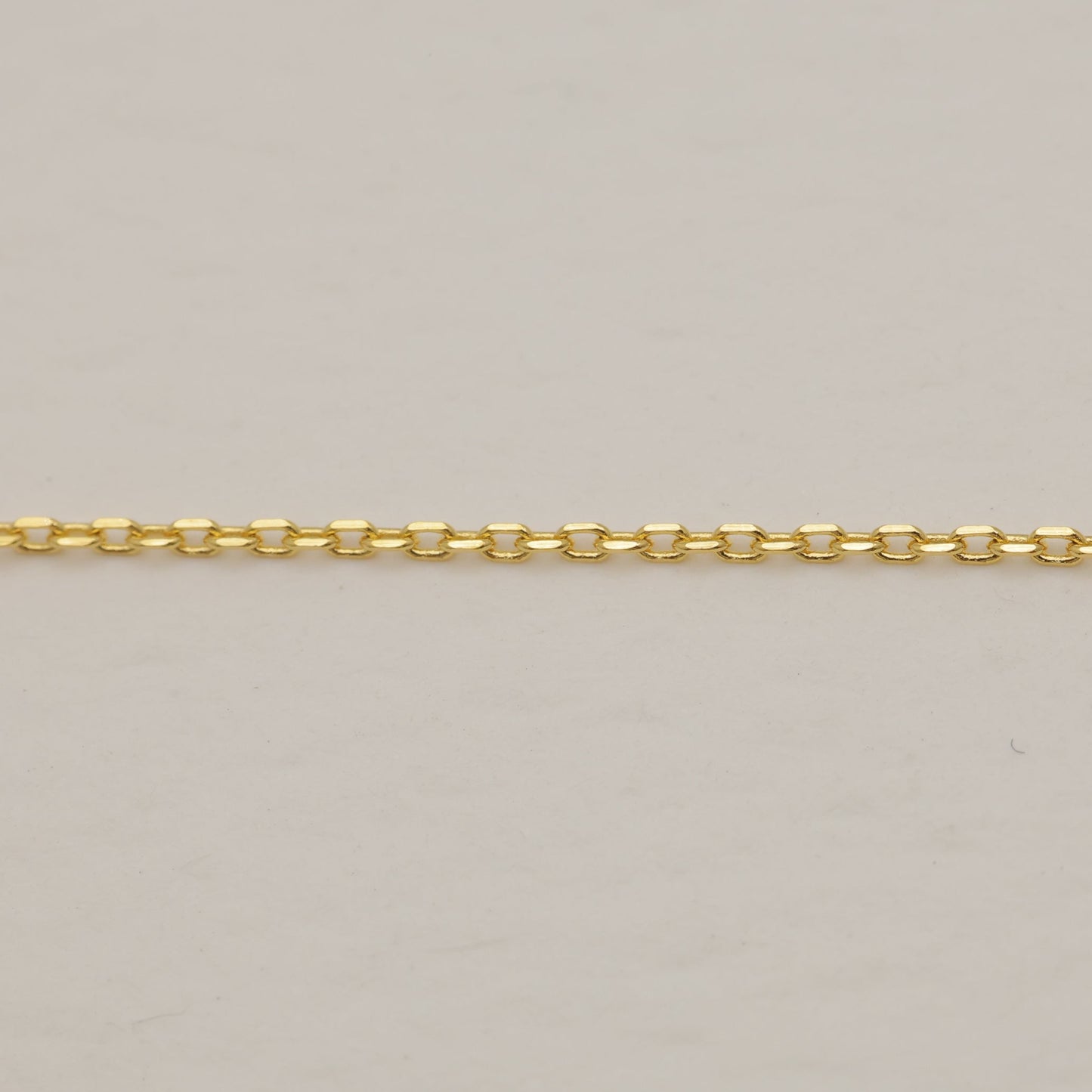 Gold chain on a beige background