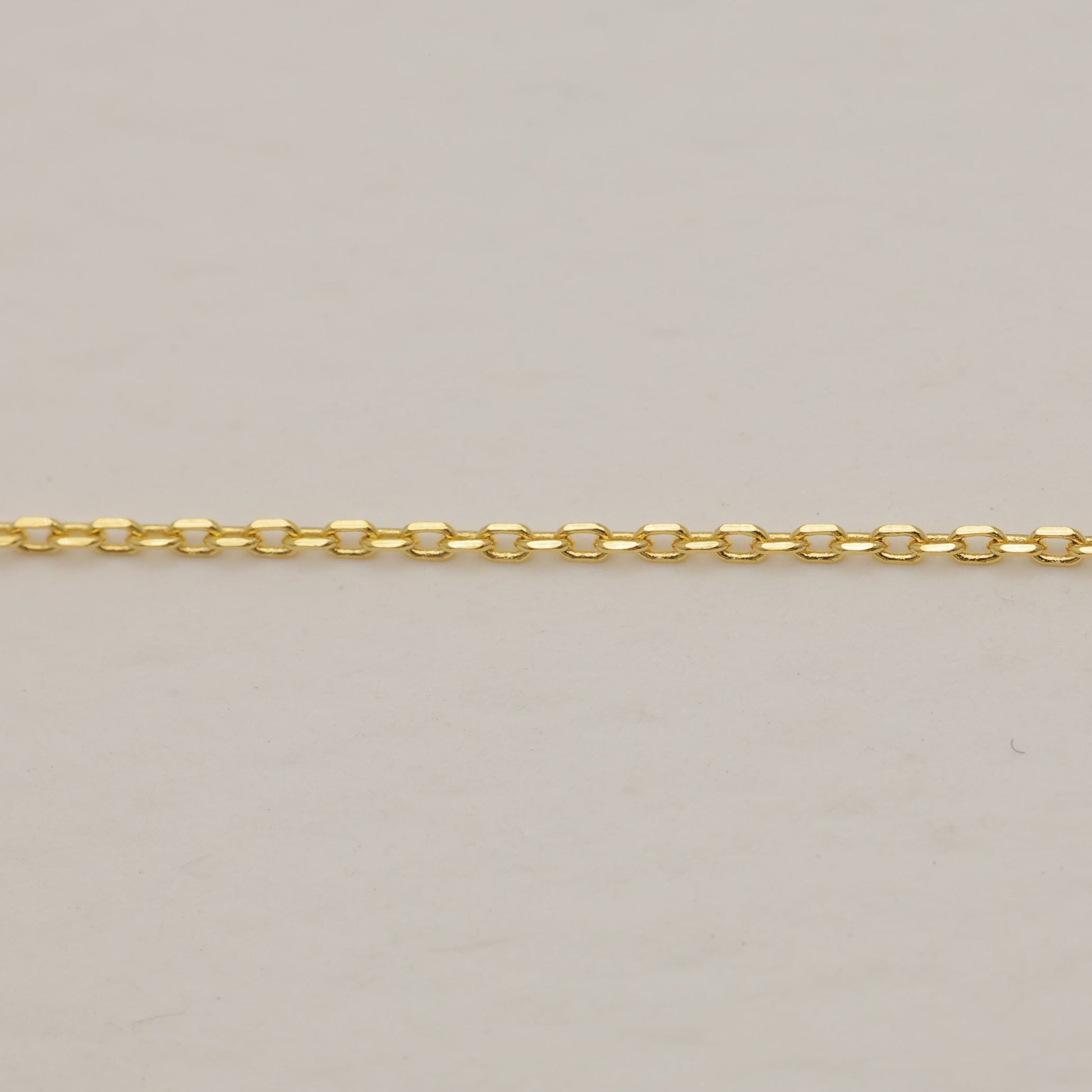 Gold chain on a beige background