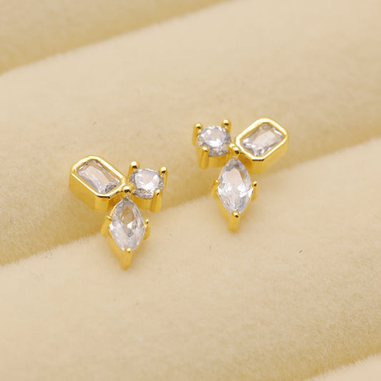 Gold vermeil stud earrings with trio-cut cubic zirconia stones.