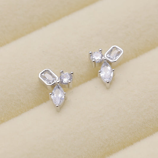 Sterling silver stud earrings with trio-cut cubic zirconia stones.