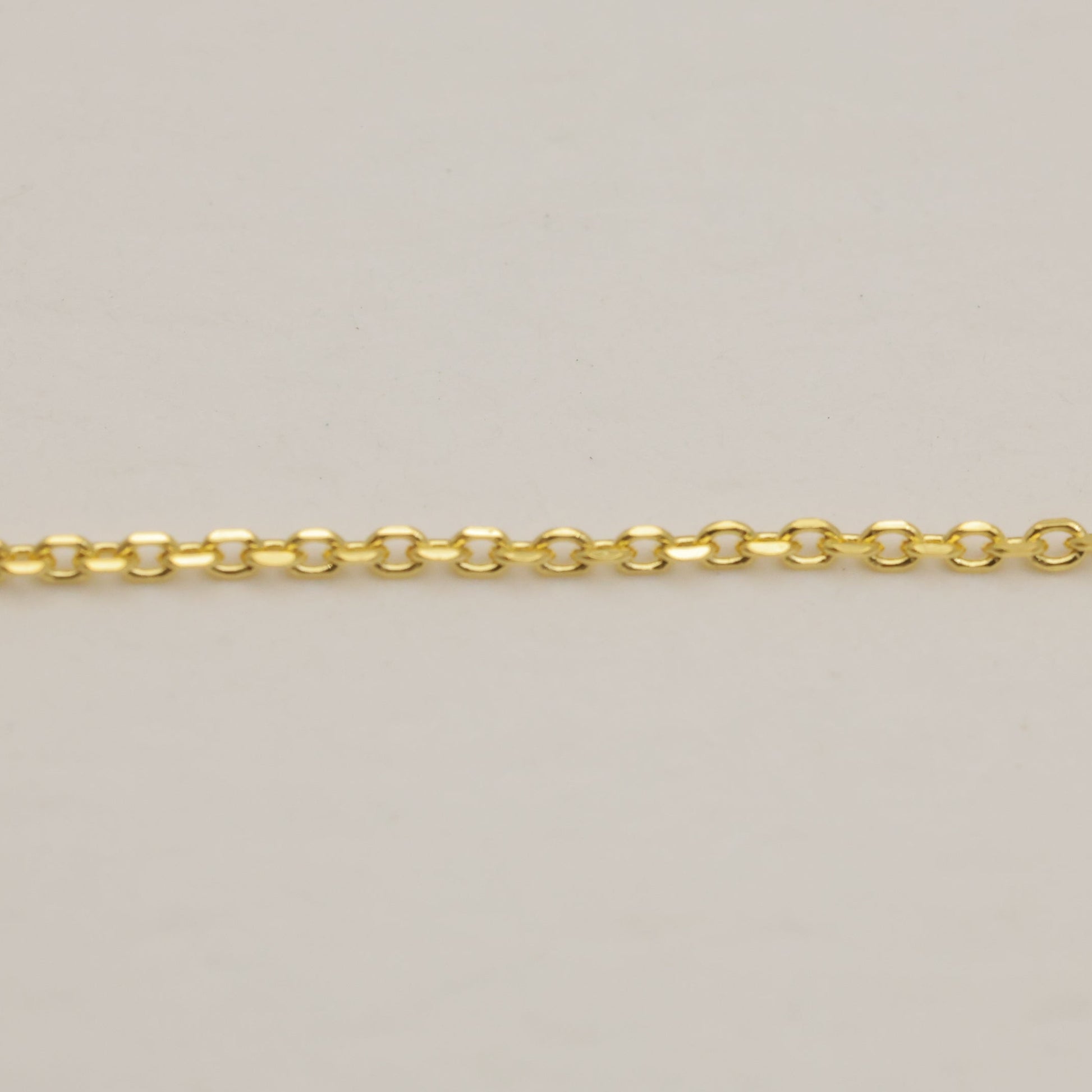 Gold chain on a beige background