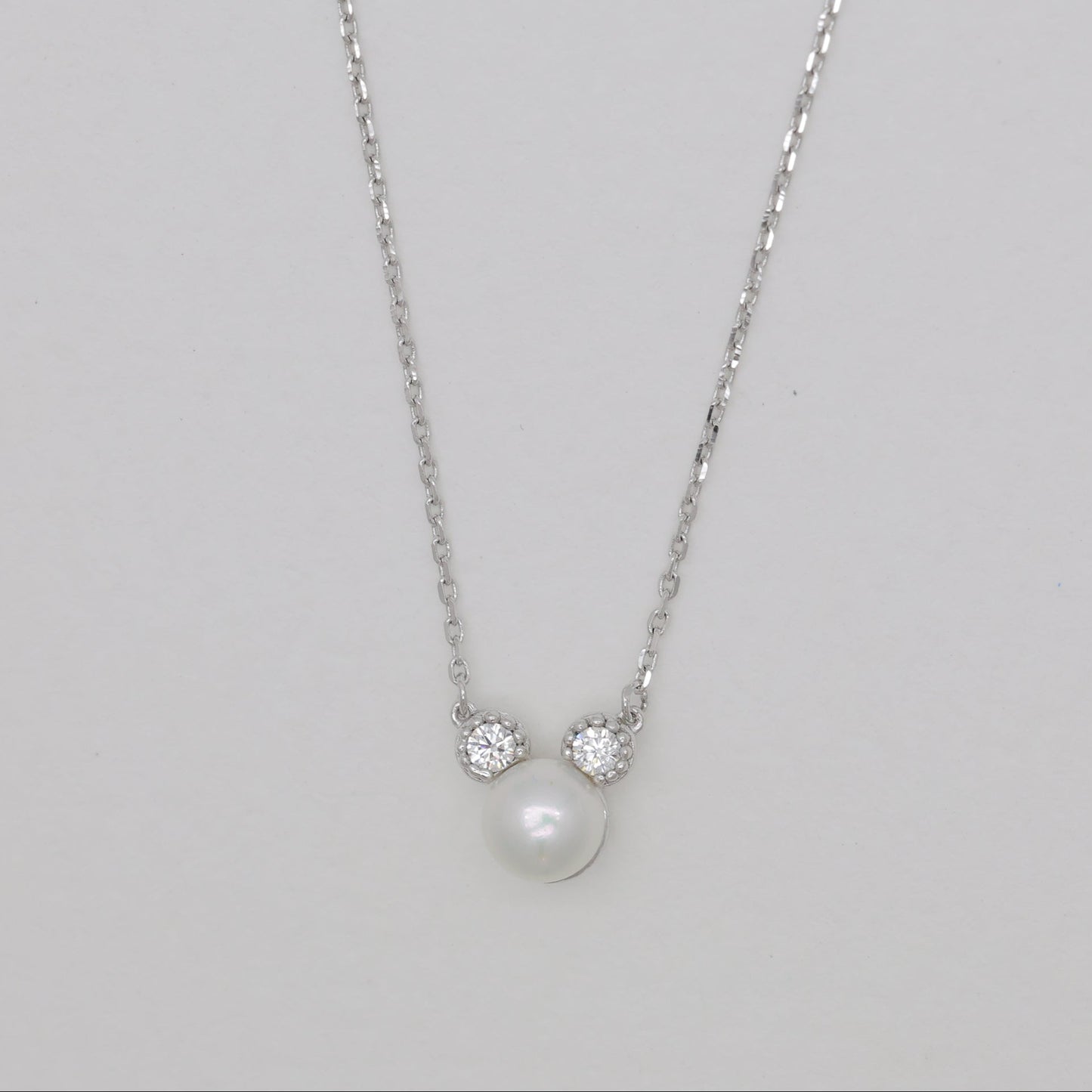 Sterling silver necklace with natural pearl and cubic zirconia accents.