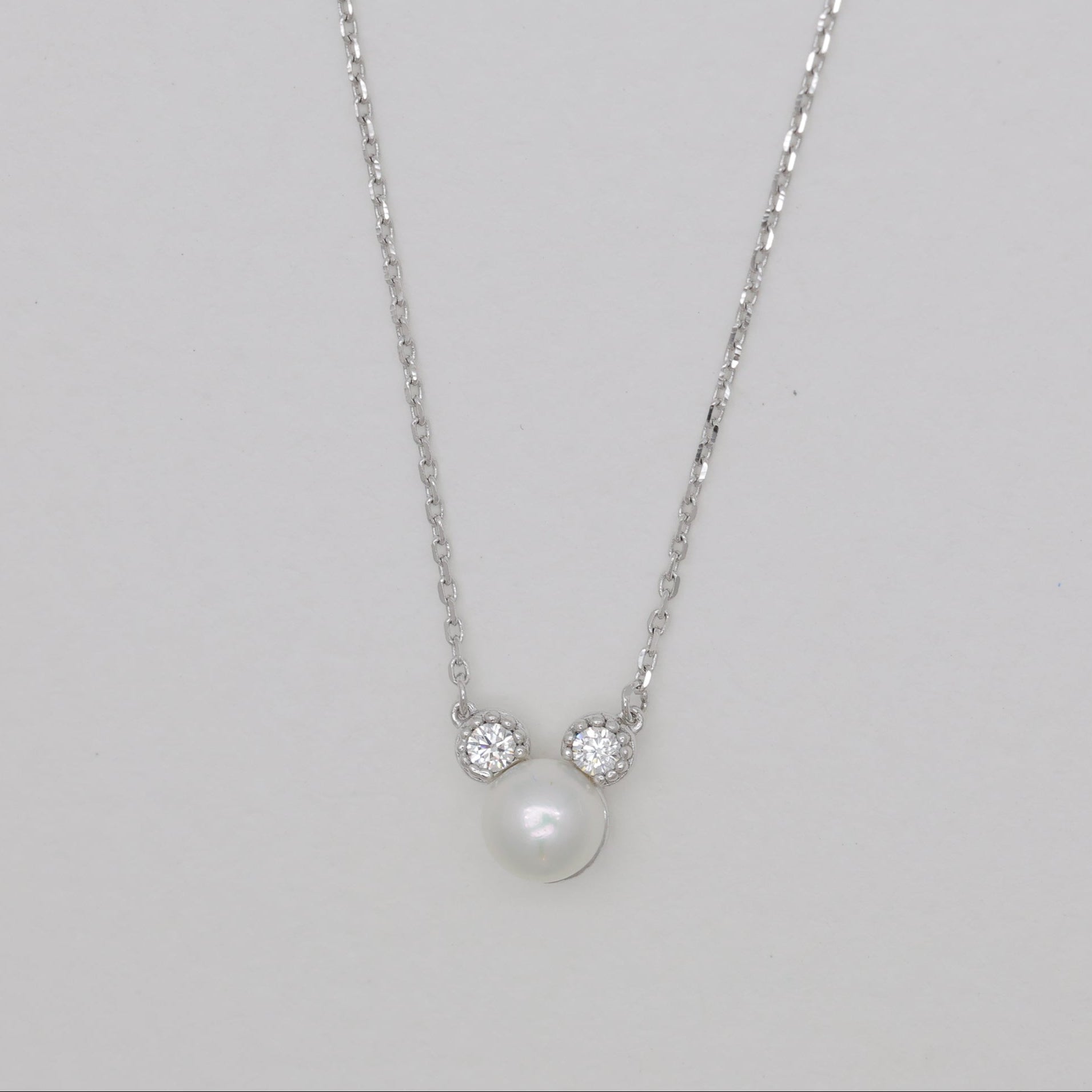 Sterling silver necklace with natural pearl and cubic zirconia accents.
