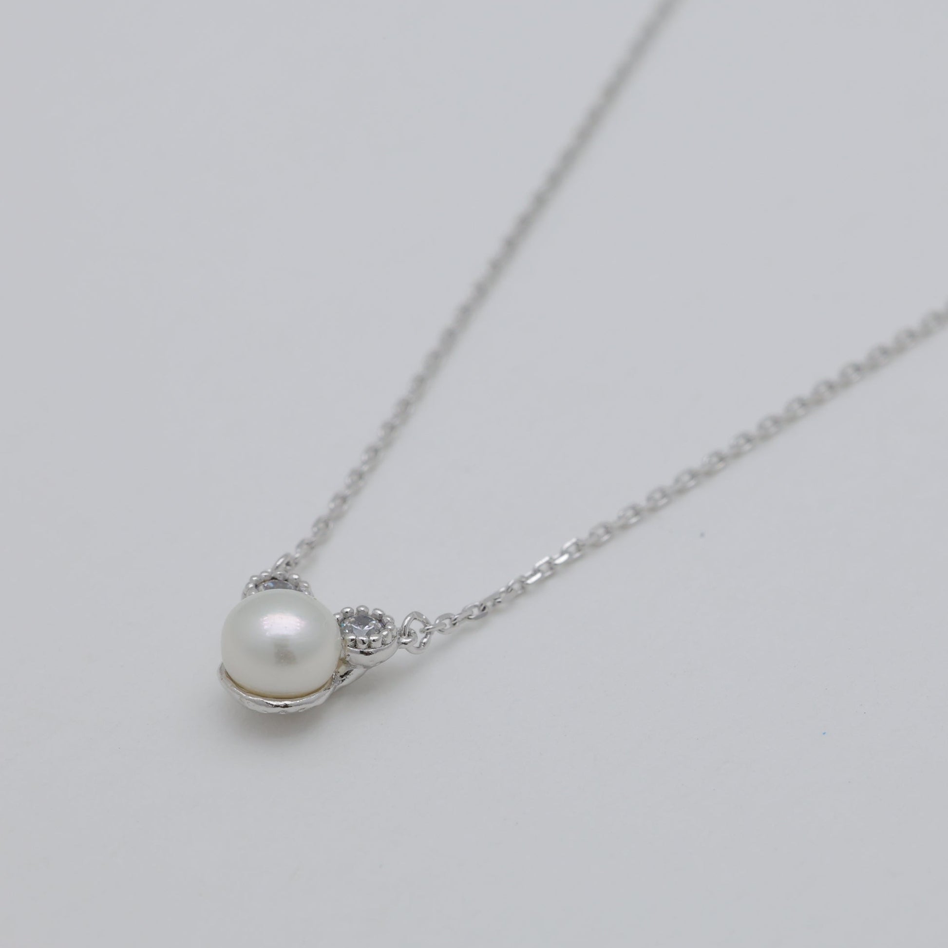 Side angle highlighting silver chain and pendant detail.