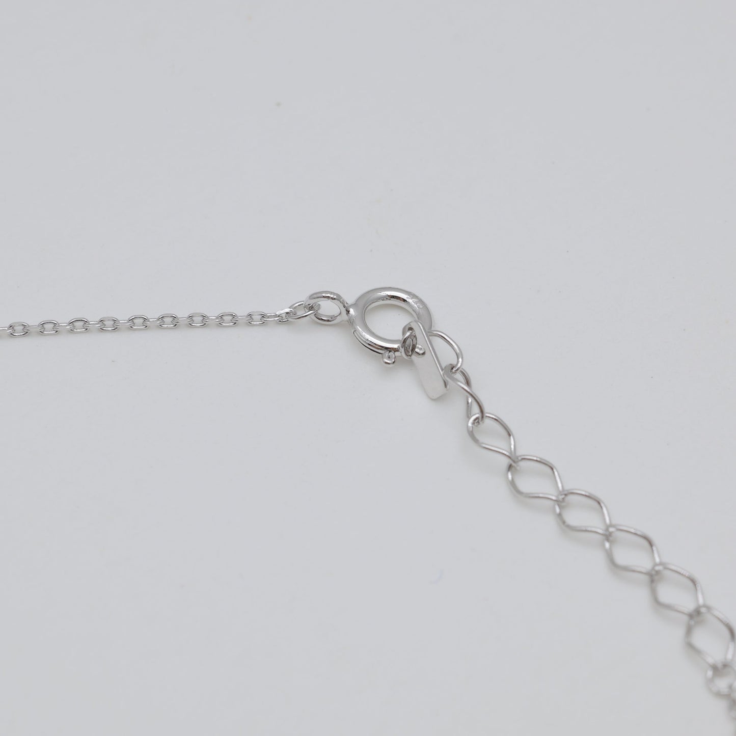 Spring clasp and adjustable chain extension.