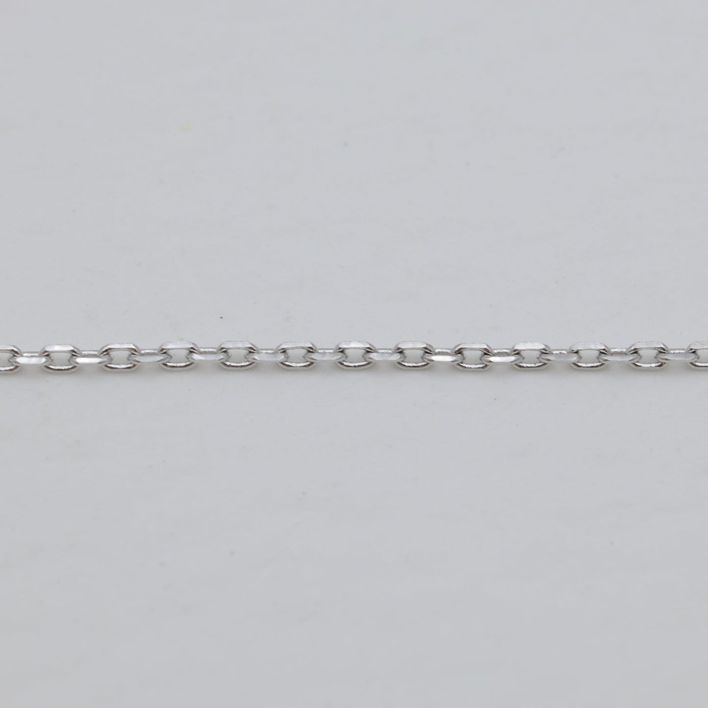 Chain texture detail in polished silver finish.