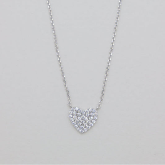 Heart-shaped diamond necklace on a light gray background