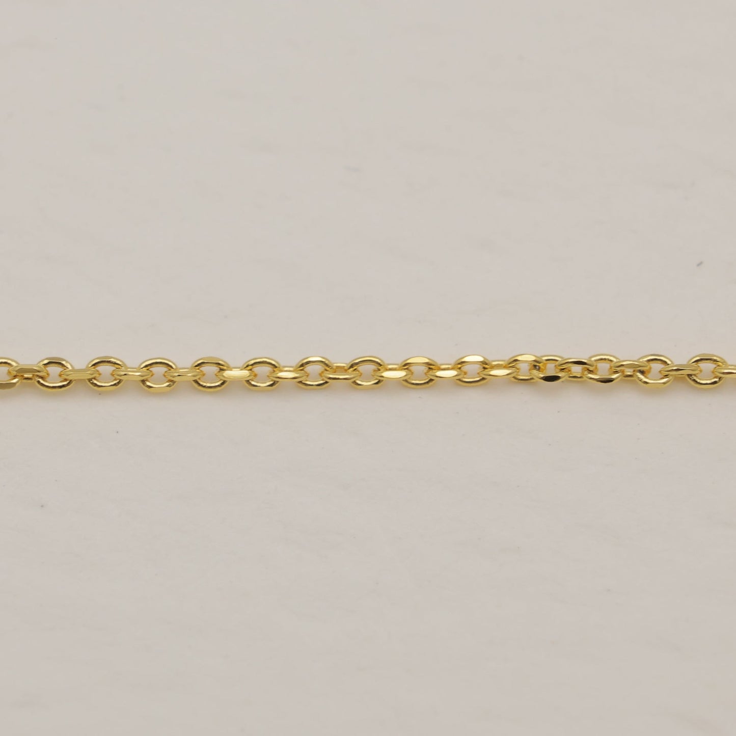 Gold chain on a beige background