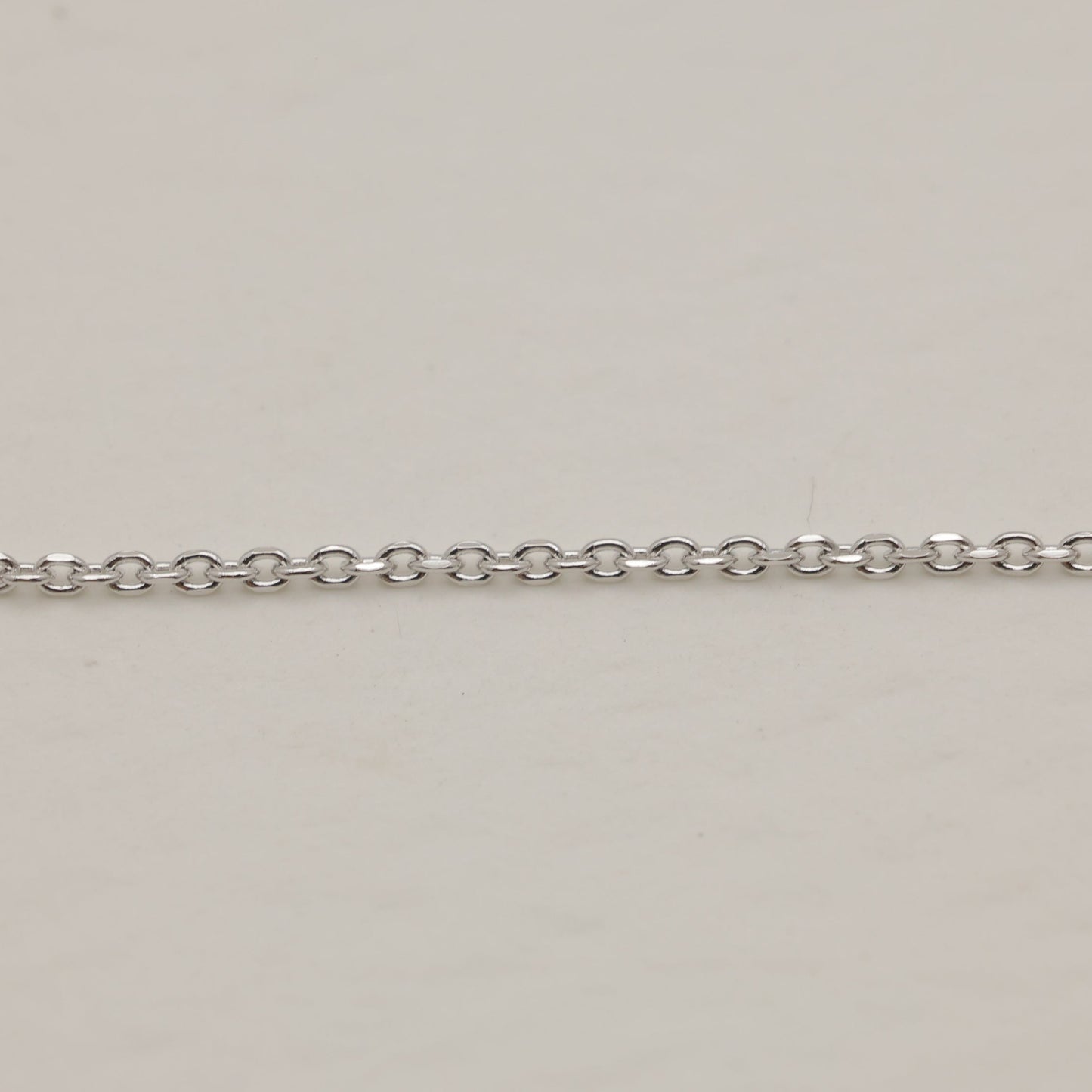 Silver chain on a beige background