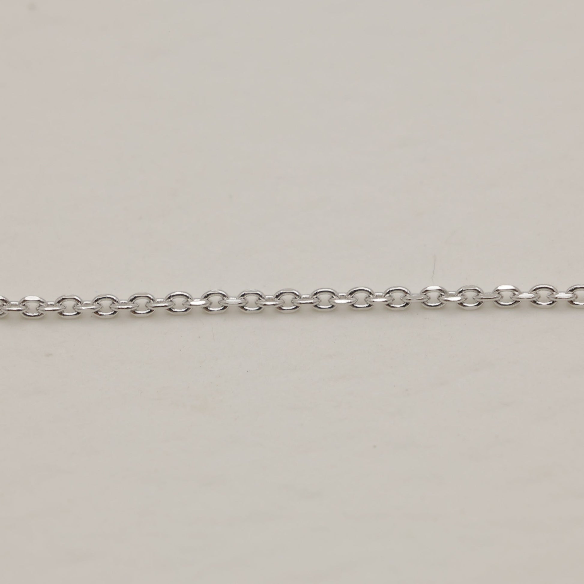 Silver chain on a beige background