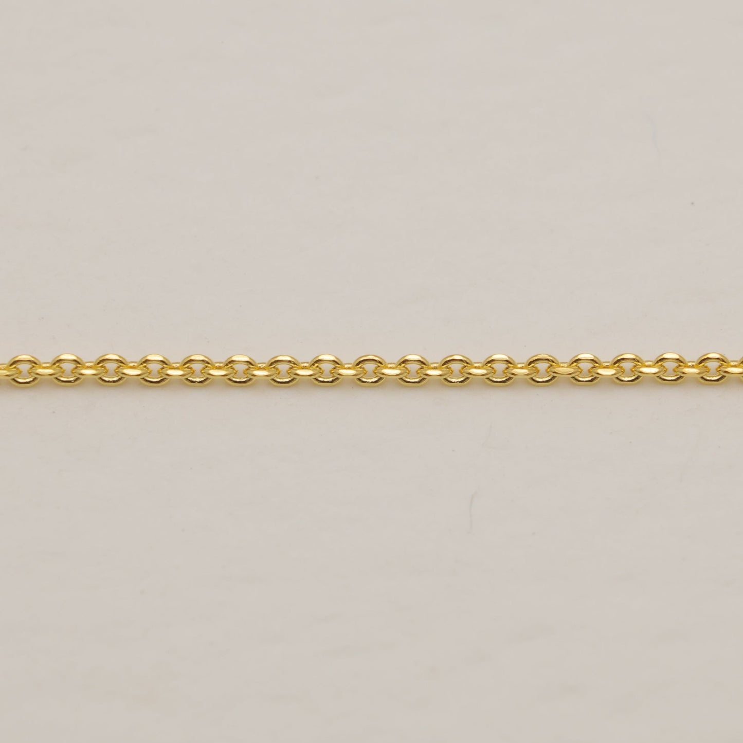Gold chain on a beige background