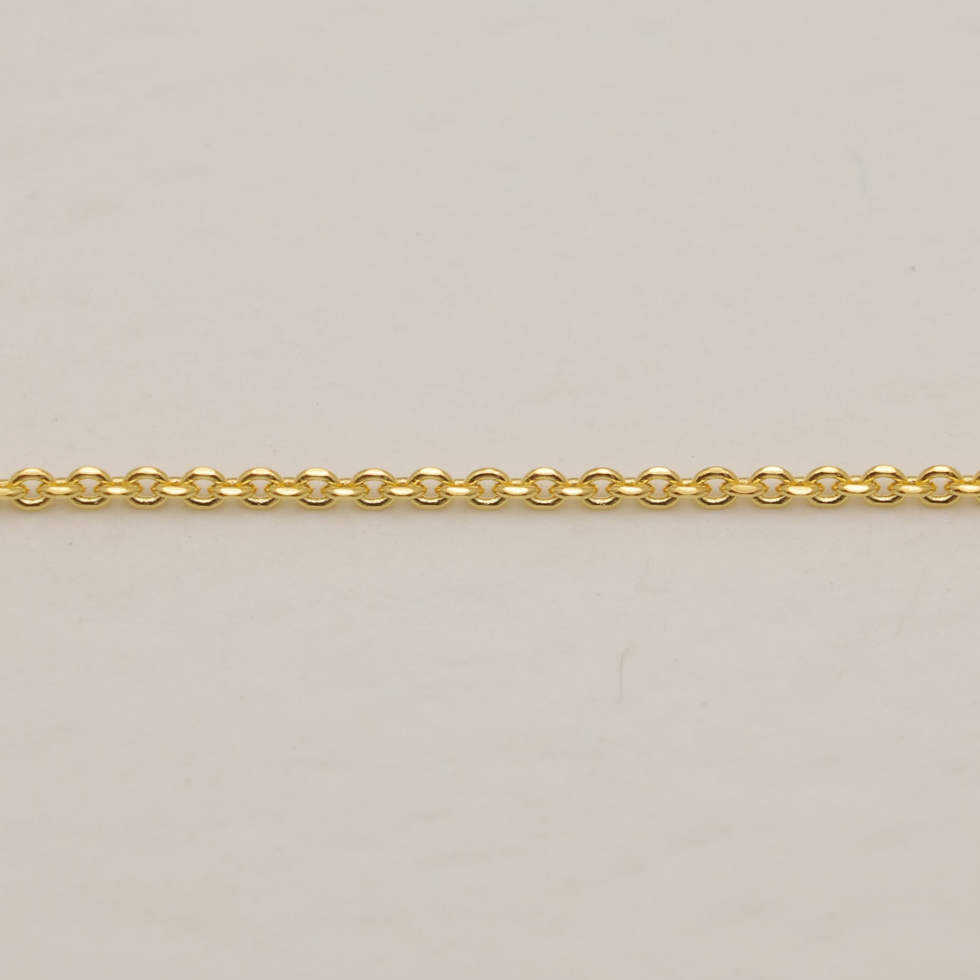 Gold chain on a beige background