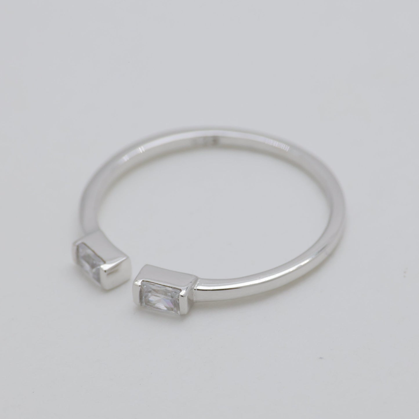 Silver ring with engraved design on a light gray background