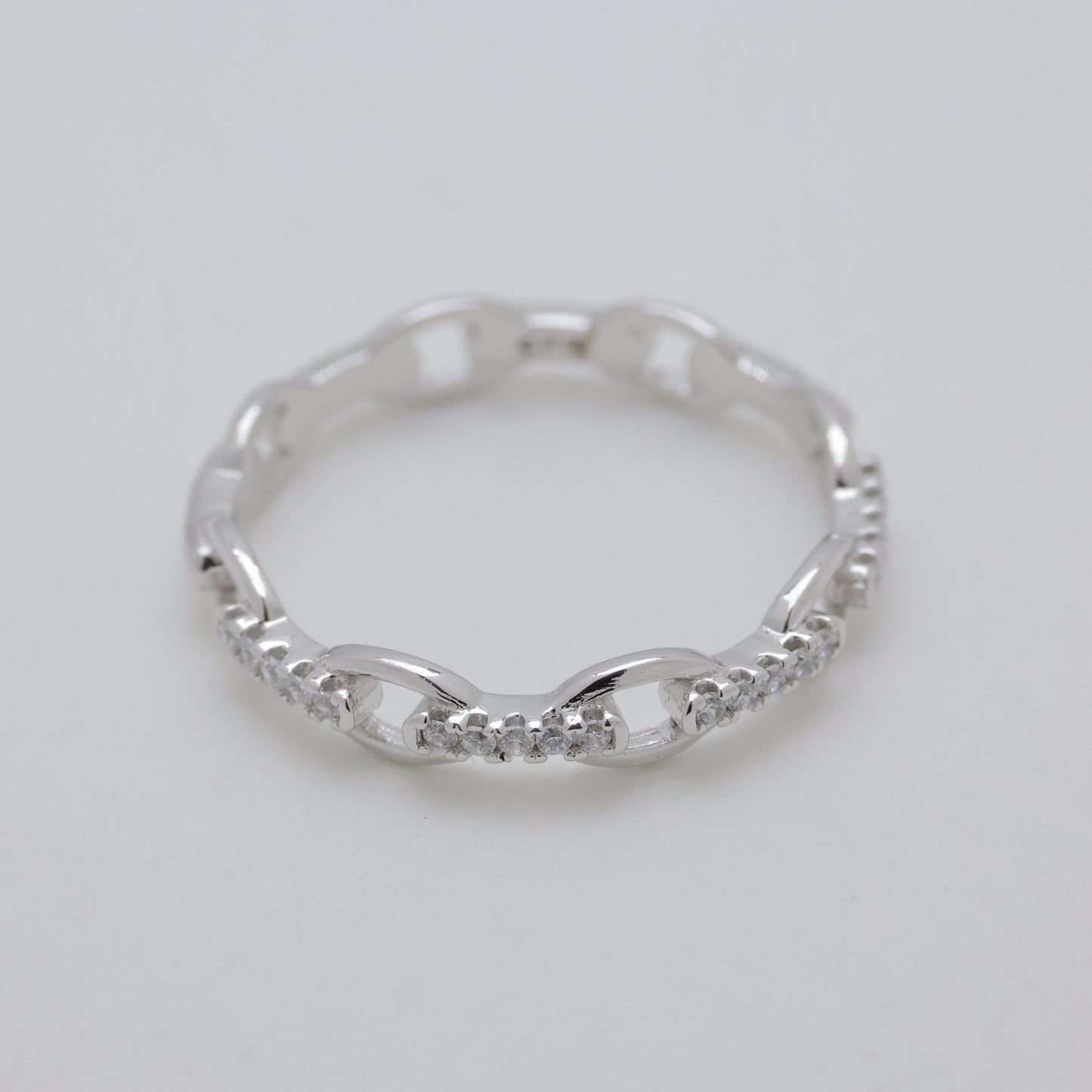 Silver ring on a light gray background