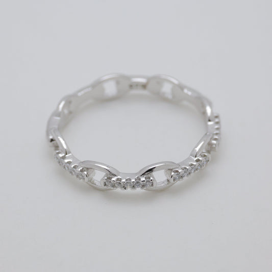 Silver ring on a light gray background