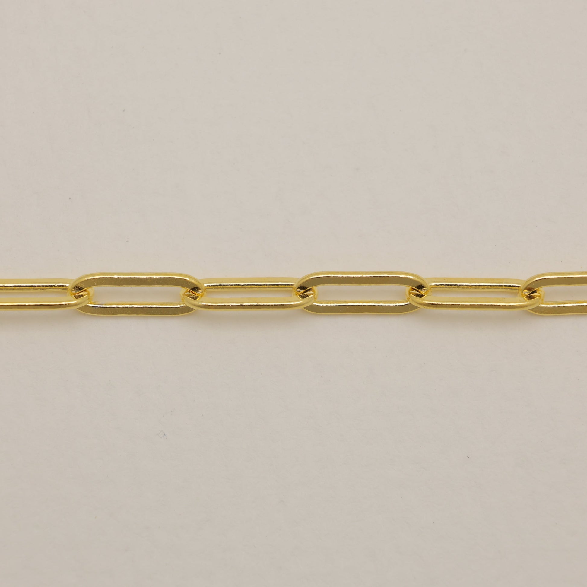 Gold chain on a beige background