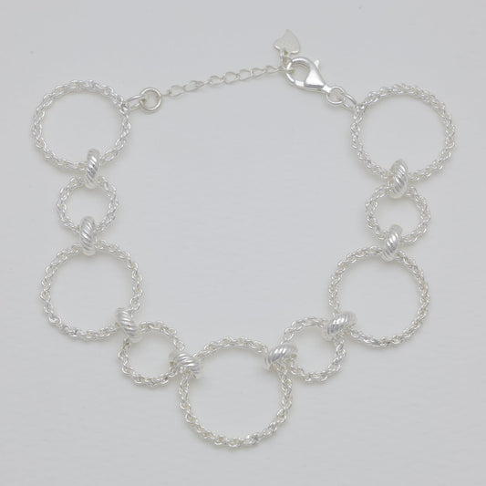 Silver chain bracelet on a light gray background