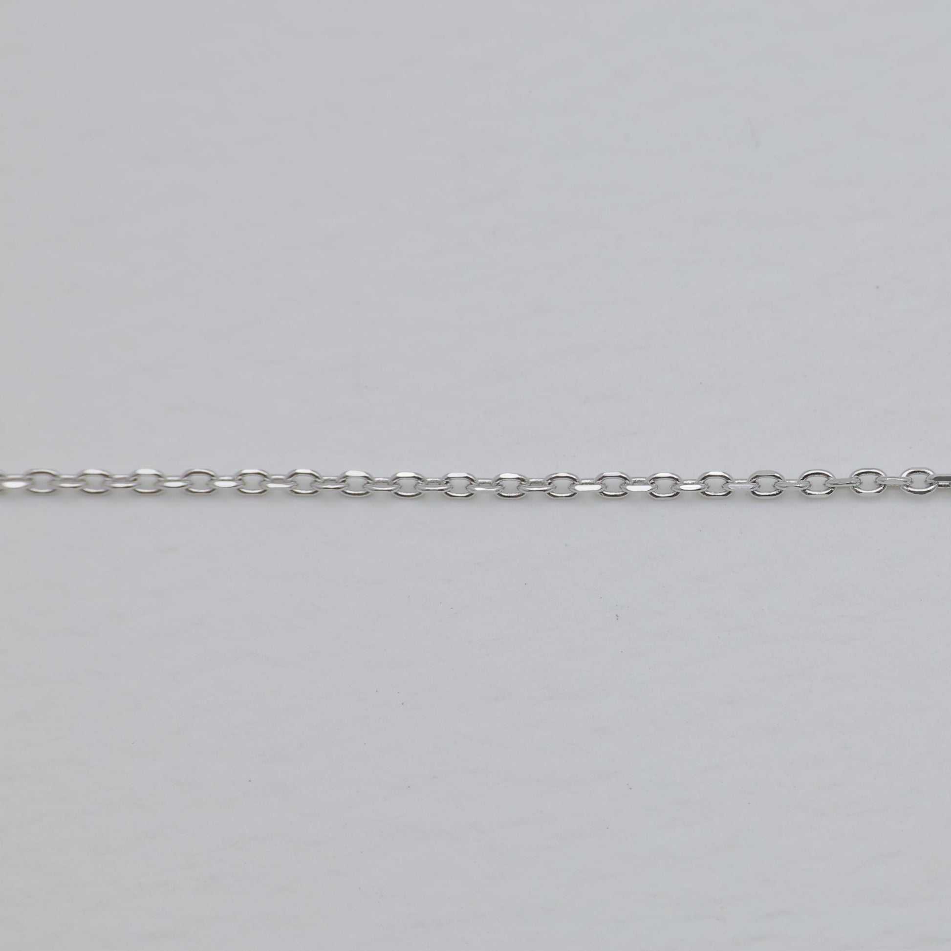 Silver chain on a light gray background