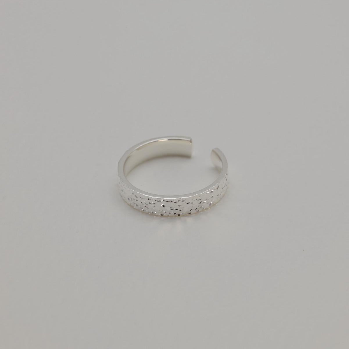 Silver ring on a gray background
