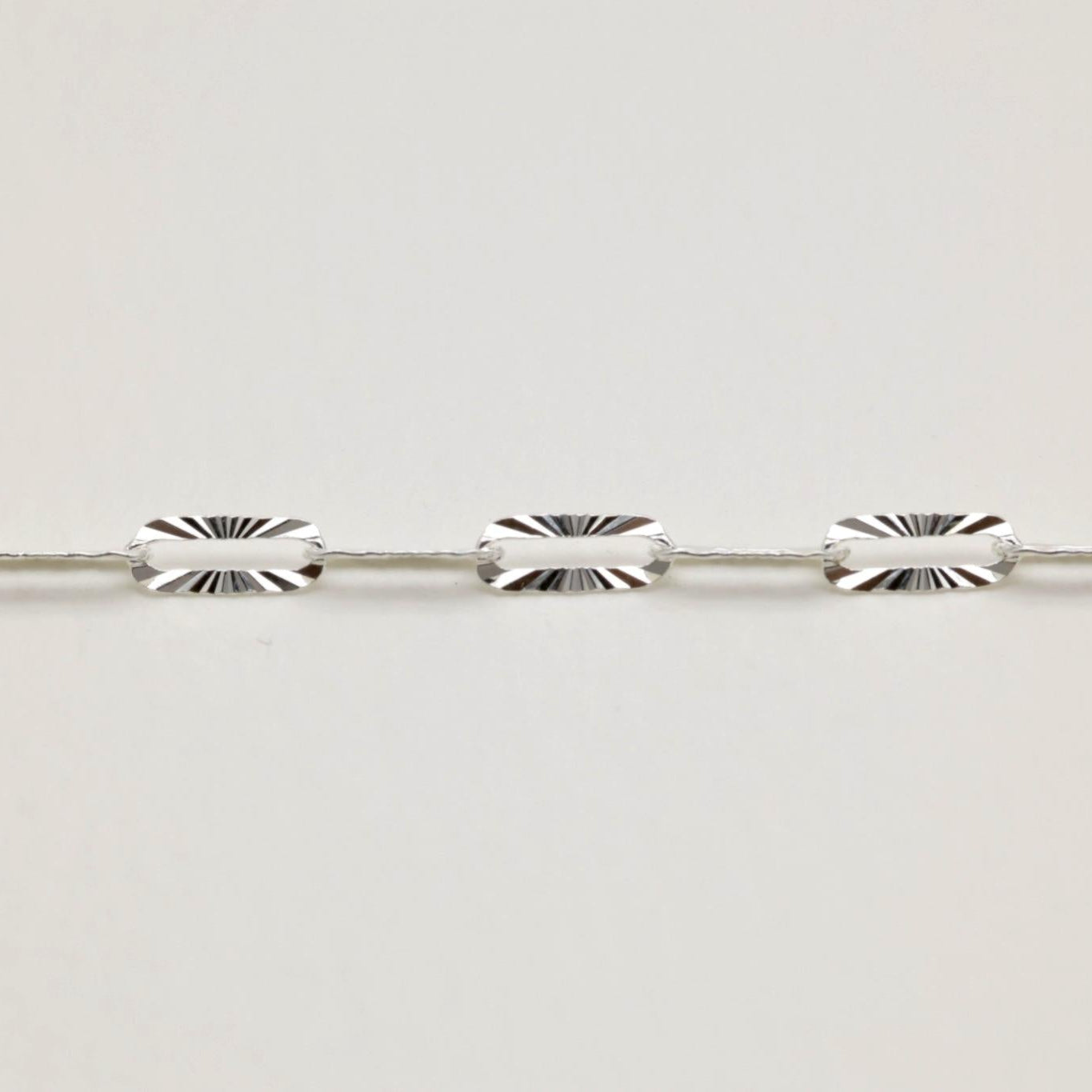 Detail shot of oval sunburst links on MOA silver bracelet

