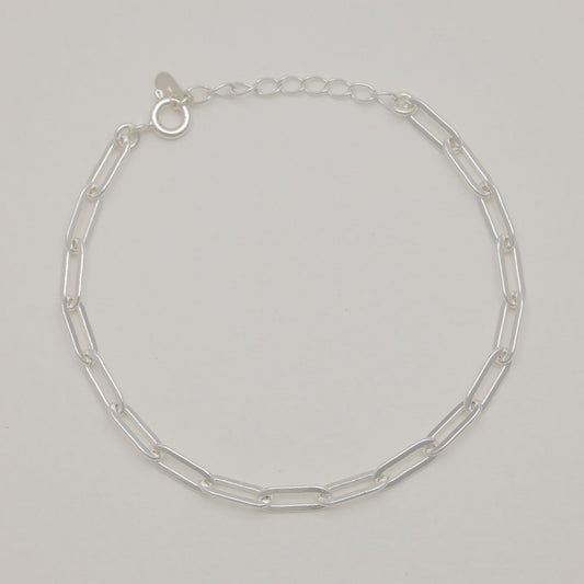 Maïa Chain Bracelet in sterling silver laid flat on soft neutral background