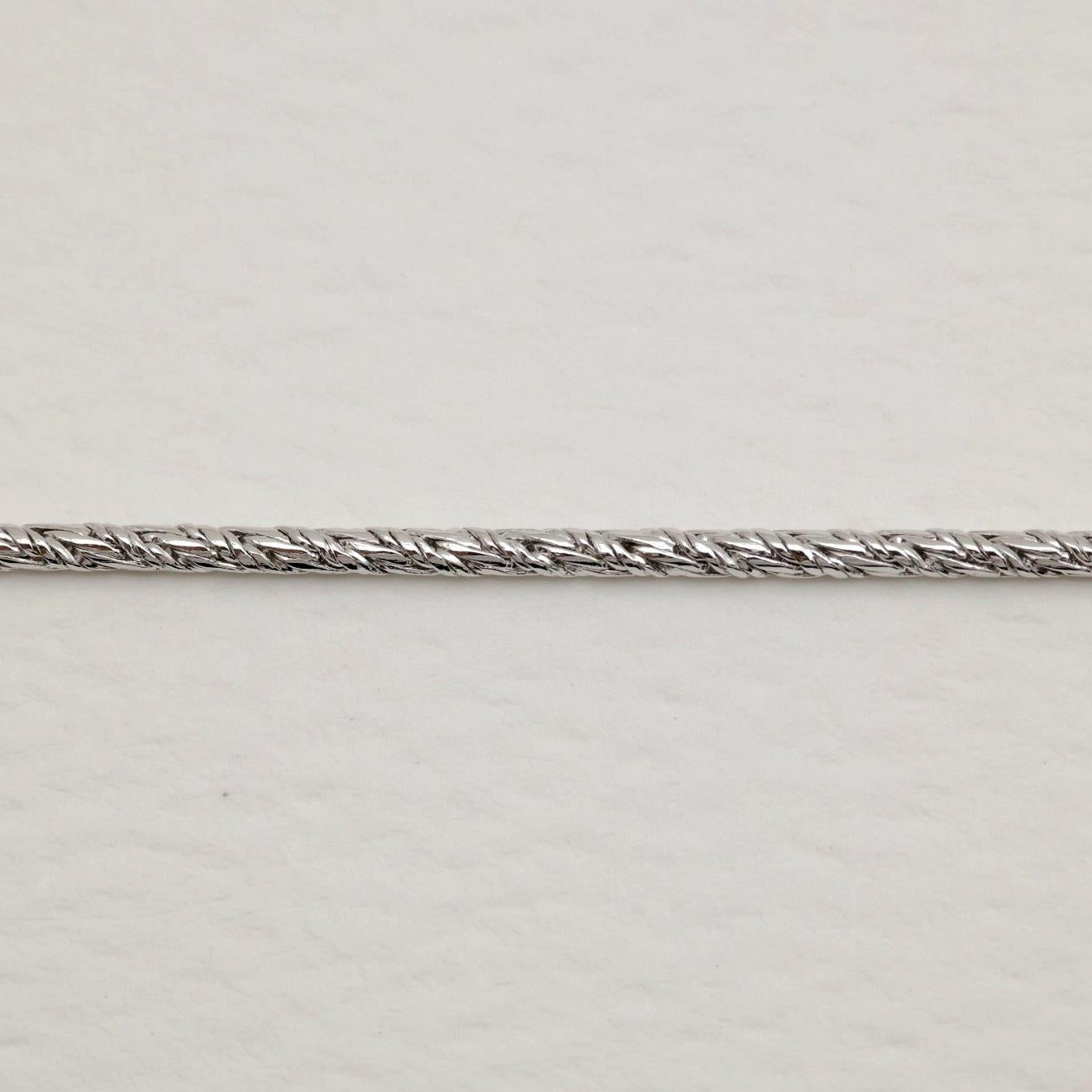 Close-up of Érine Chain Bracelet showing tightly braided sterling silver wheat chain.