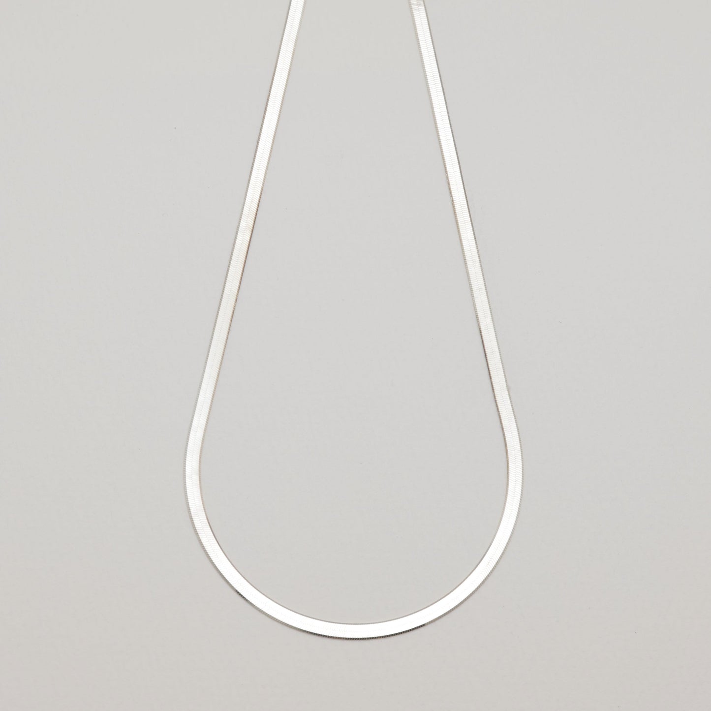 Full view of the Margaux Chain Necklace in sterling silver laid flat on neutral background