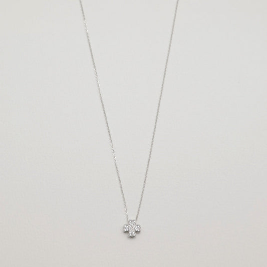 Full view of the Fleur Necklace in sterling silver with cubic zirconia floral pendant on a white background