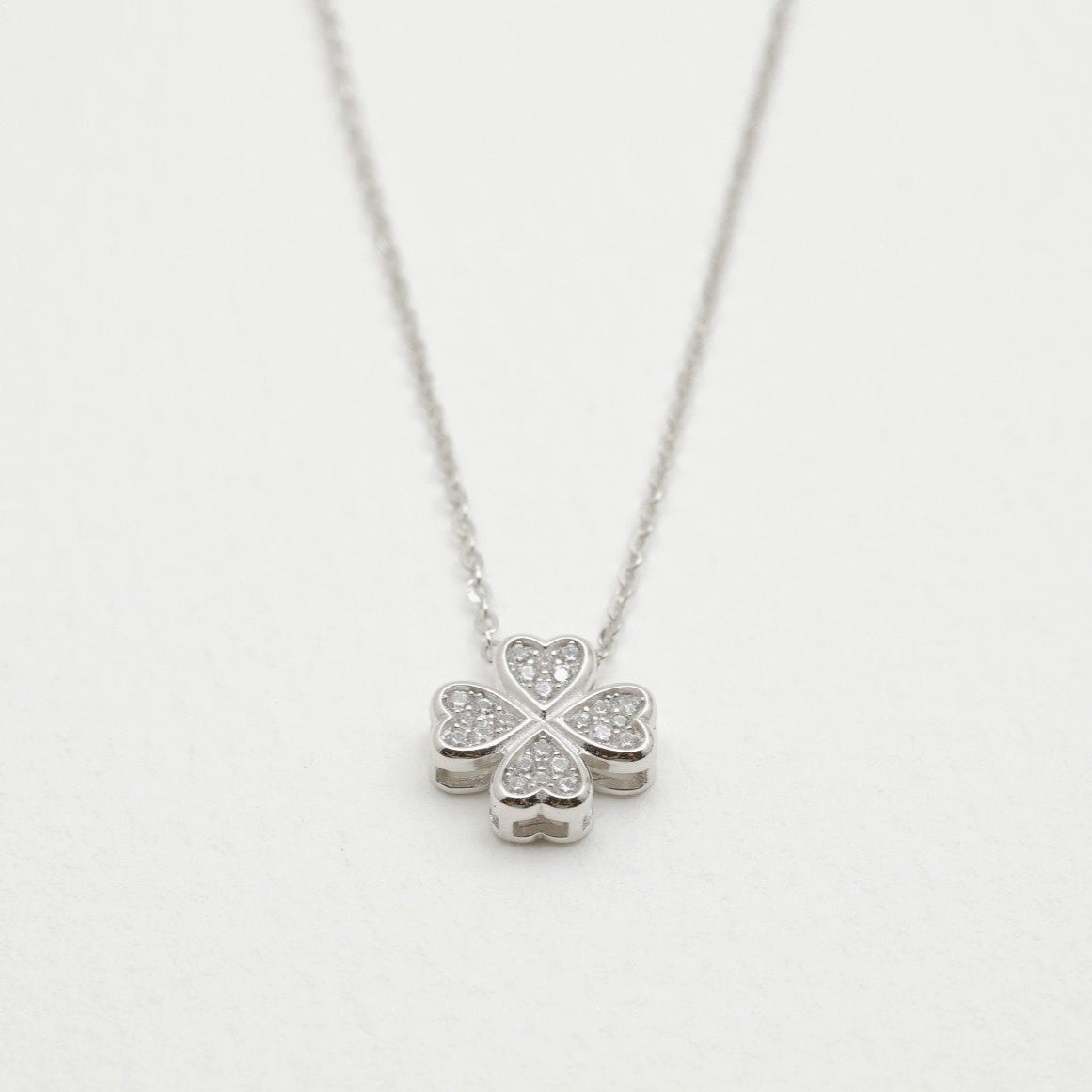 Close-up of the cubic zirconia clover-shaped pendant on the Fleur Necklace