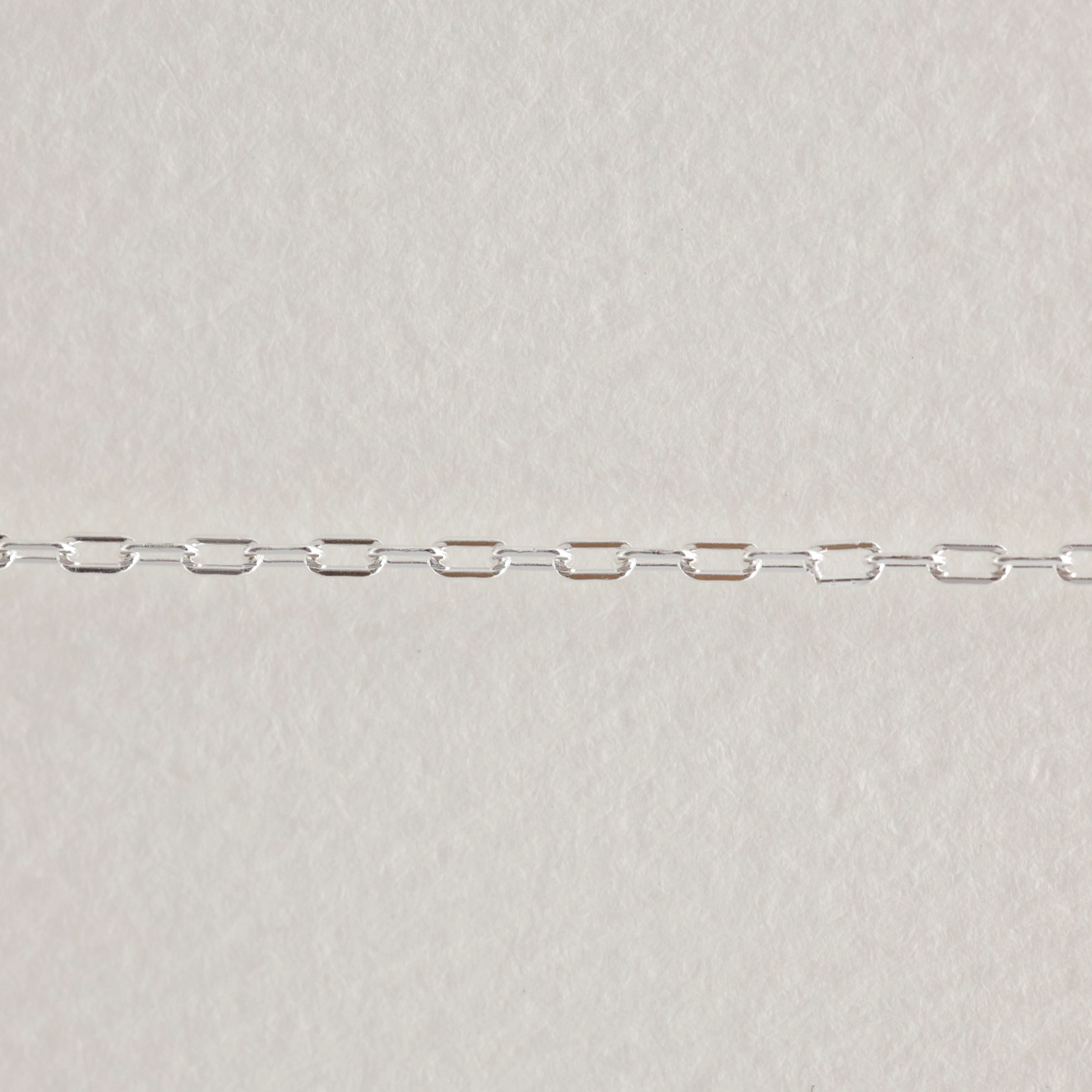 Close-up of fine rectangular link chain in 925 sterling silver – part of an 80cm necklace.