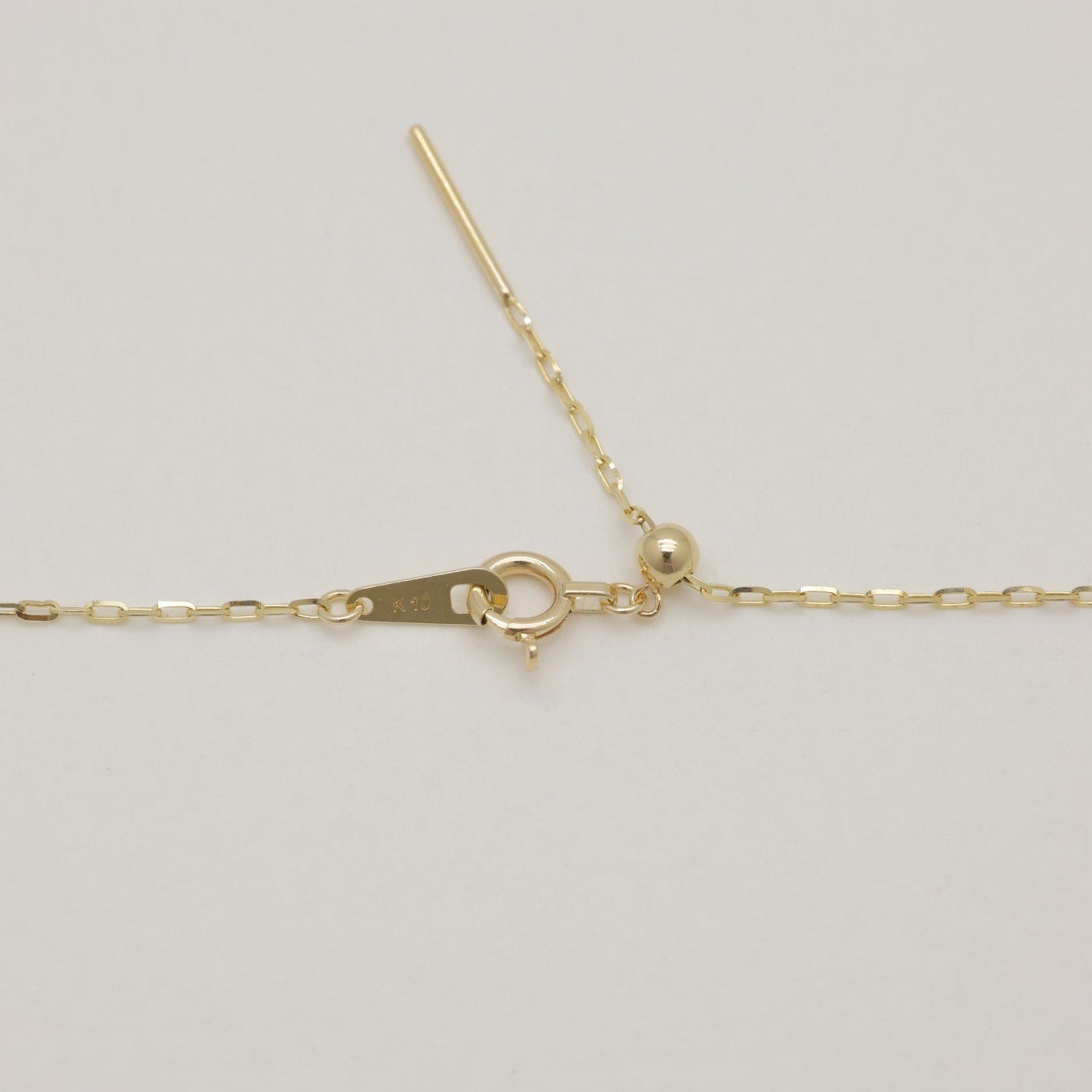 Detailed shot of clasp and adjustable slider on the 10K gold Aurélie Chain Necklace