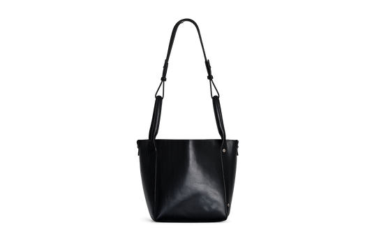 Black vegetable-tanned leather bag with structured shape and panel detailing