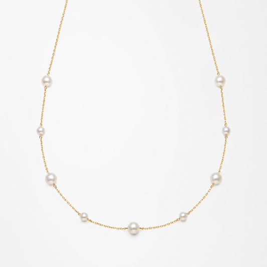 Pearl necklace on a light beige background