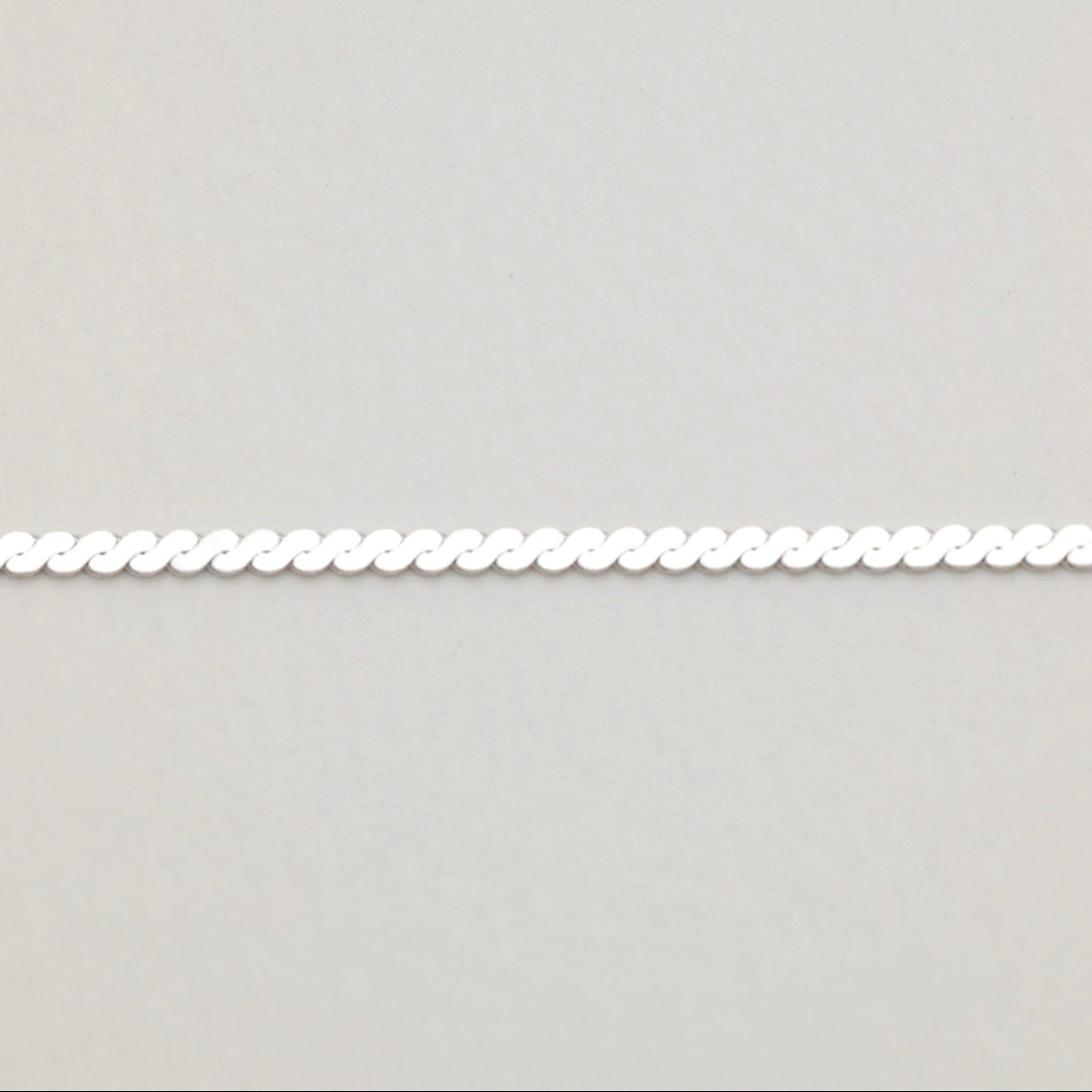 Zoomed-in image of the reverse polished side of the Cléa Chain Necklace for a clean, mirror-like finish.
