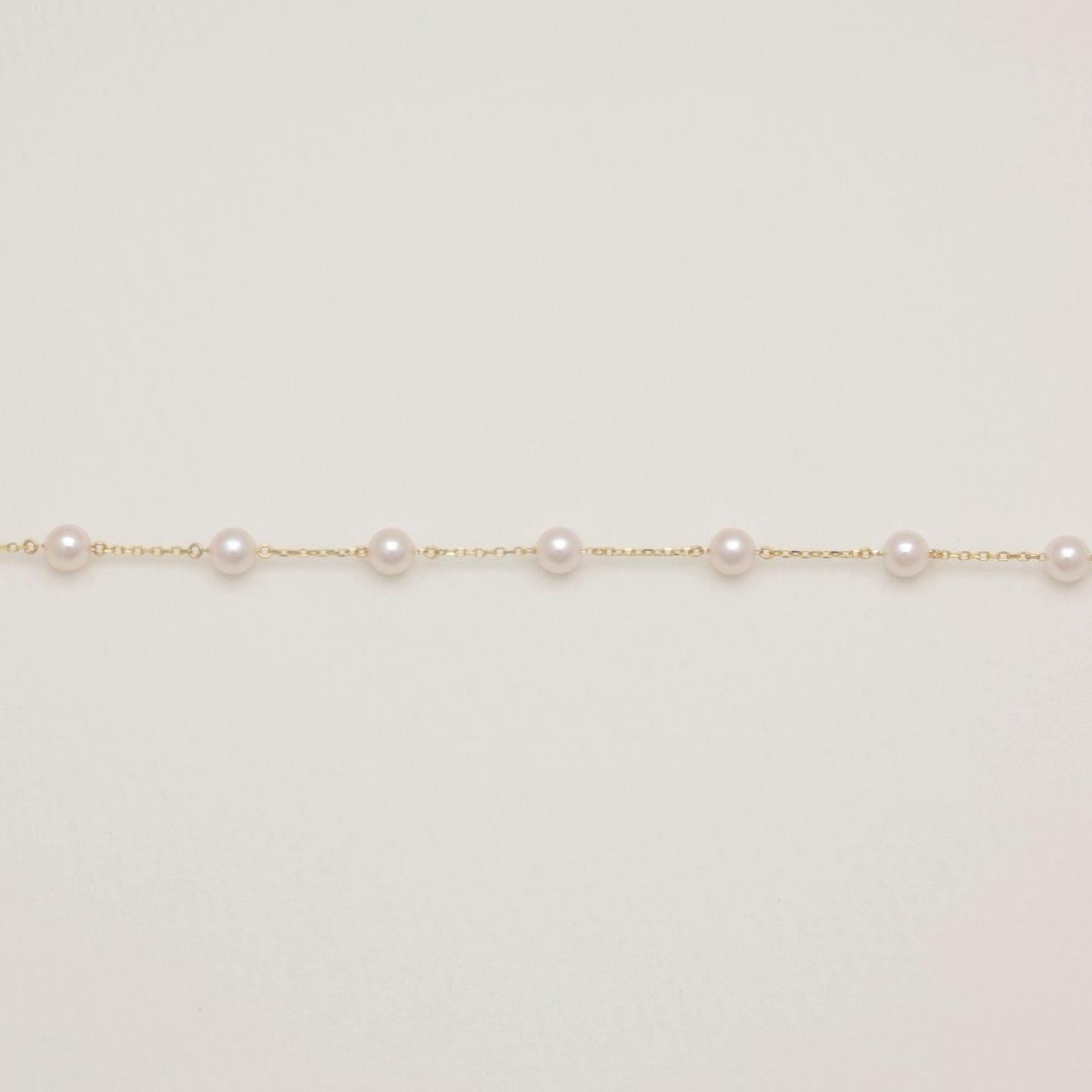 Necklace with small pearls on a light background