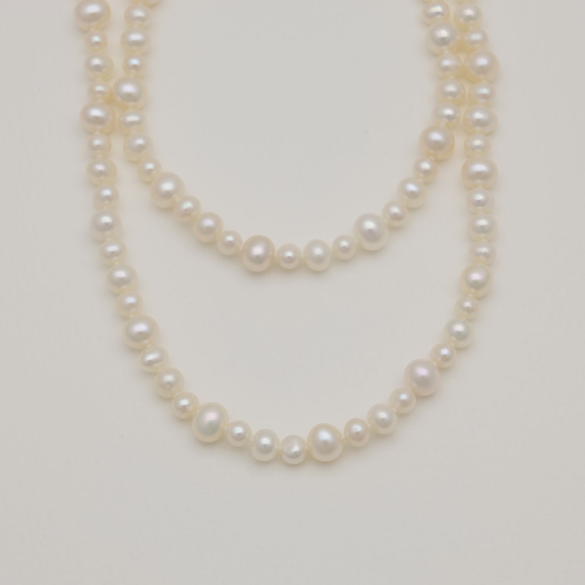 Close-up of 5–6mm freshwater pearls with soft sheen.