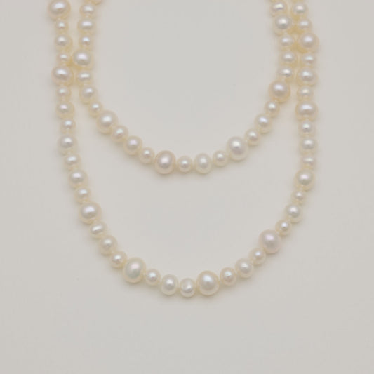 Close-up of 5–6mm freshwater pearls with soft sheen.