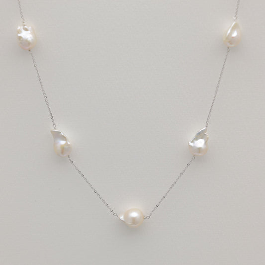 Long baroque pearl necklace in sterling silver featuring irregular freshwater pearls.