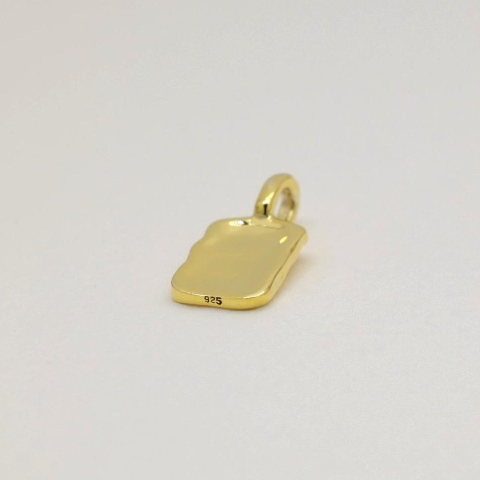 Gold vermeil rectangular tag pendant with soft rippled texture, photographed on a neutral background.