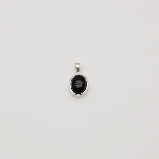 Sterling silver pendant with black onyx stone in a round bezel setting. Clean, minimal, and elegant.