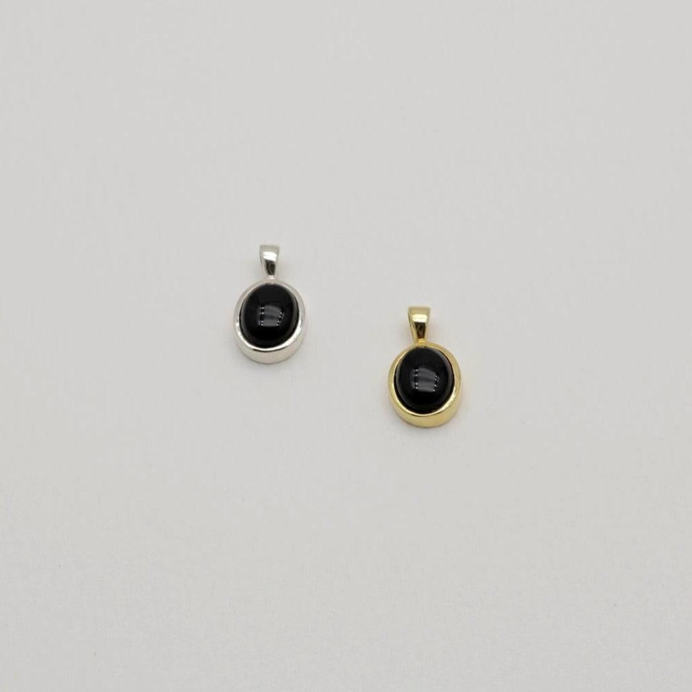 Arianne gold vermeil pendant with oval onyx stone on neutral background

