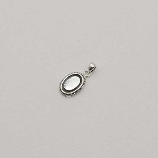 Sterling silver oval pendant with polished centre and oxidized rope edge, shown alone and styled with matching Séraphine ring.