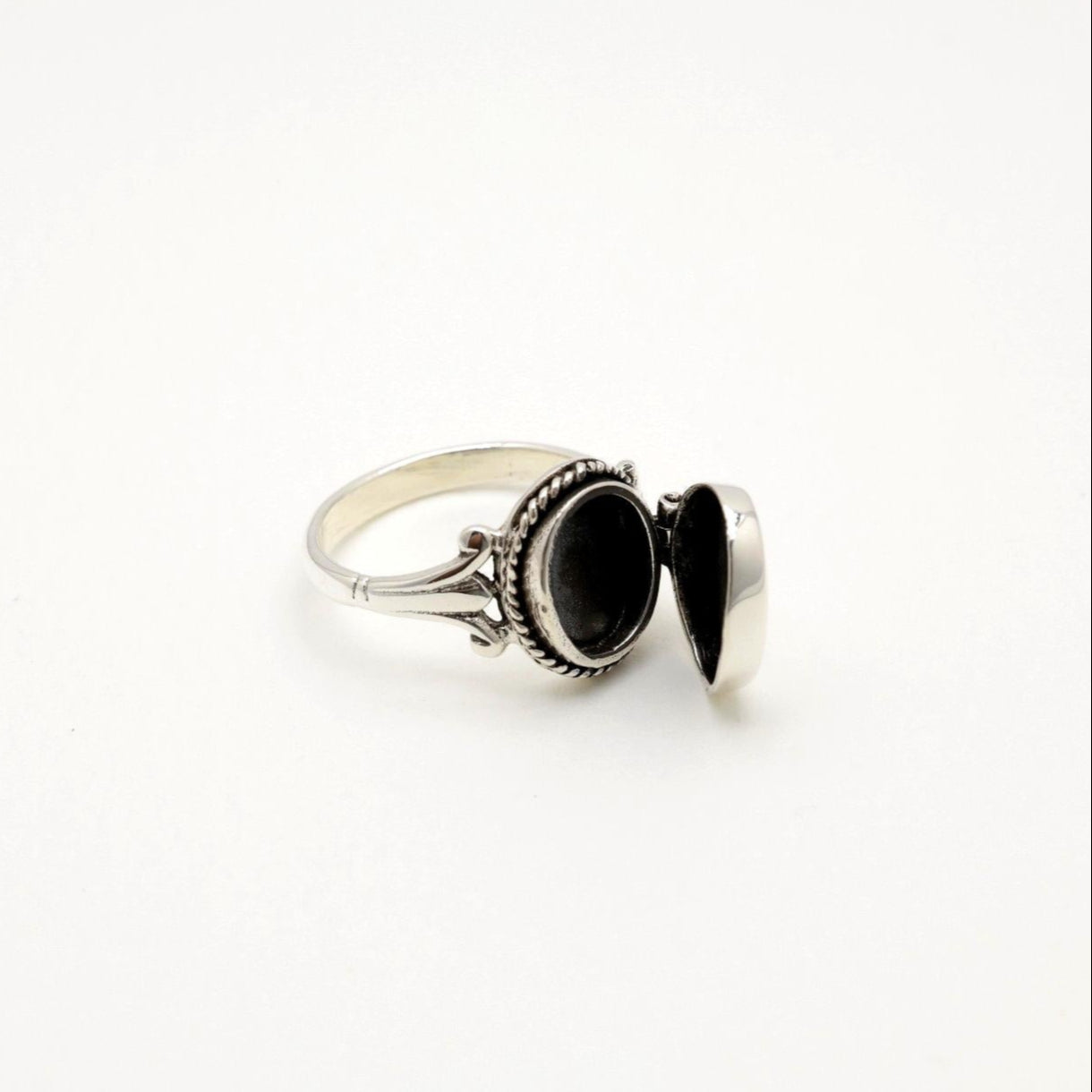 Sterling silver locket ring shown partially open, revealing hidden compartment
