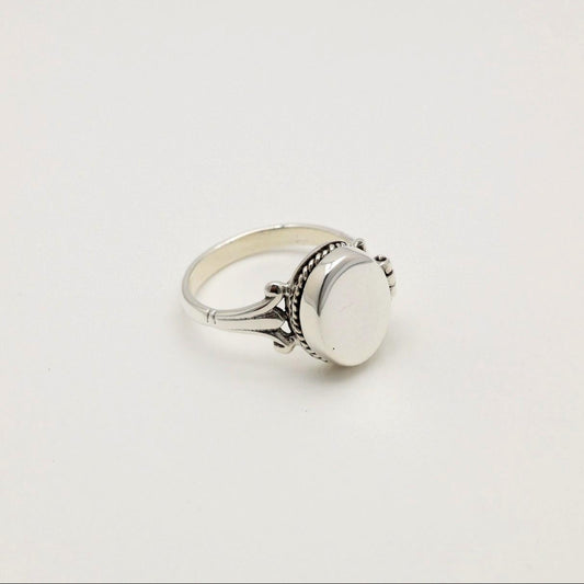 Straight-on view of Séraphine Ring with closed locket lid